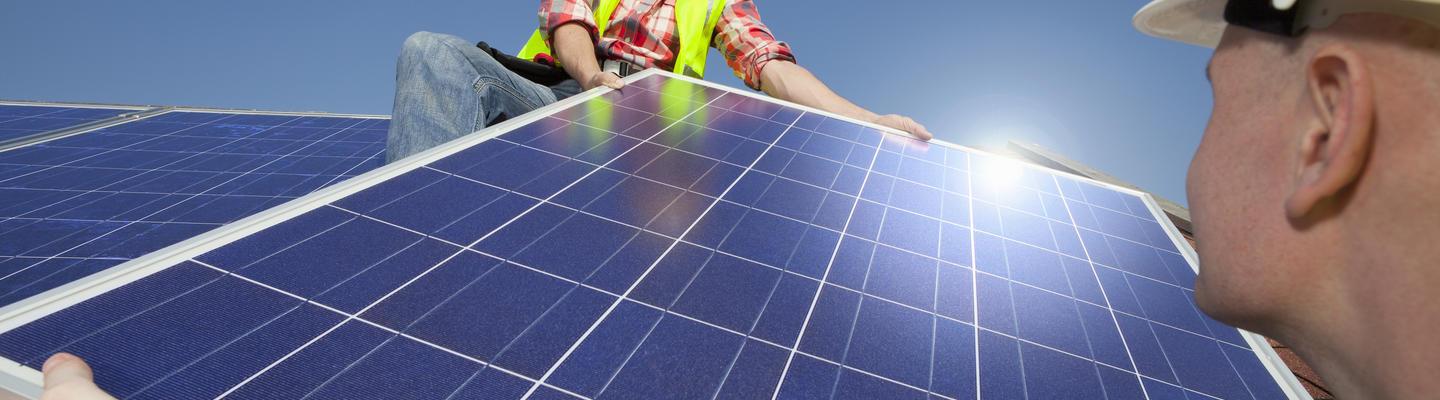 men installing solar panels